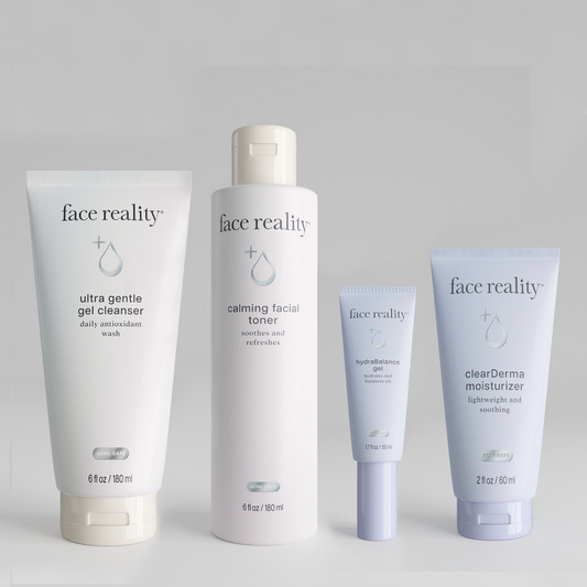 Face Reality products ultra gentle gel cleanser, calming facial toner, hydrabalance gel, and clearderma moisturizer standing side by side from left to right on a grey background.