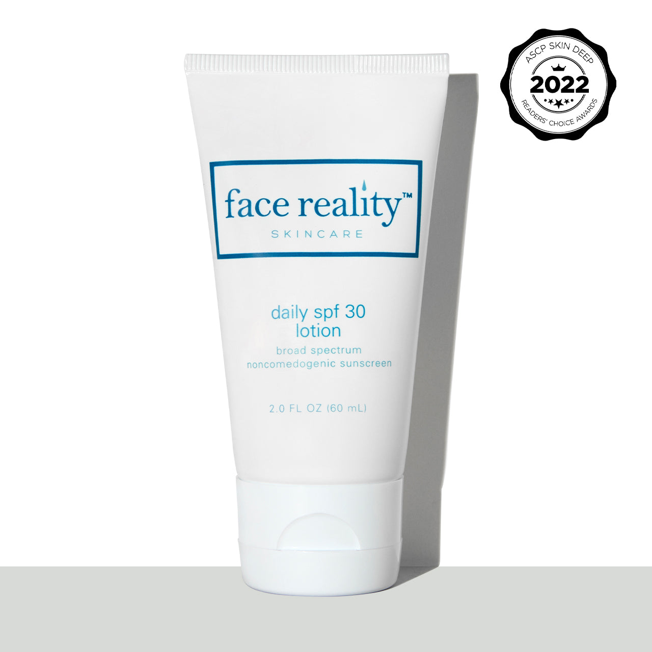 White two ounce bottle of Face Reality Daily SPF Lotion with ASCP Skin Deep 2022 Readers Choice Awards Stamp