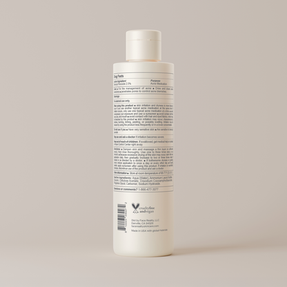 White bottle with label on a beige background
