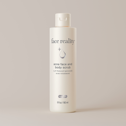 White bottle of face reality acne face and body scrub on a light gray background