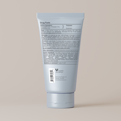Back view of a blue sunscreen tube with text on a beige background