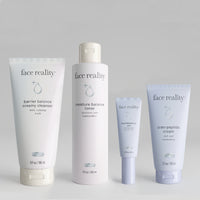 Face Reality Products; barrier balance creamy cleanser, moisture balance toner, hydrabalance gel, and cran-peptide cream side by side from left to right on a light grey background.