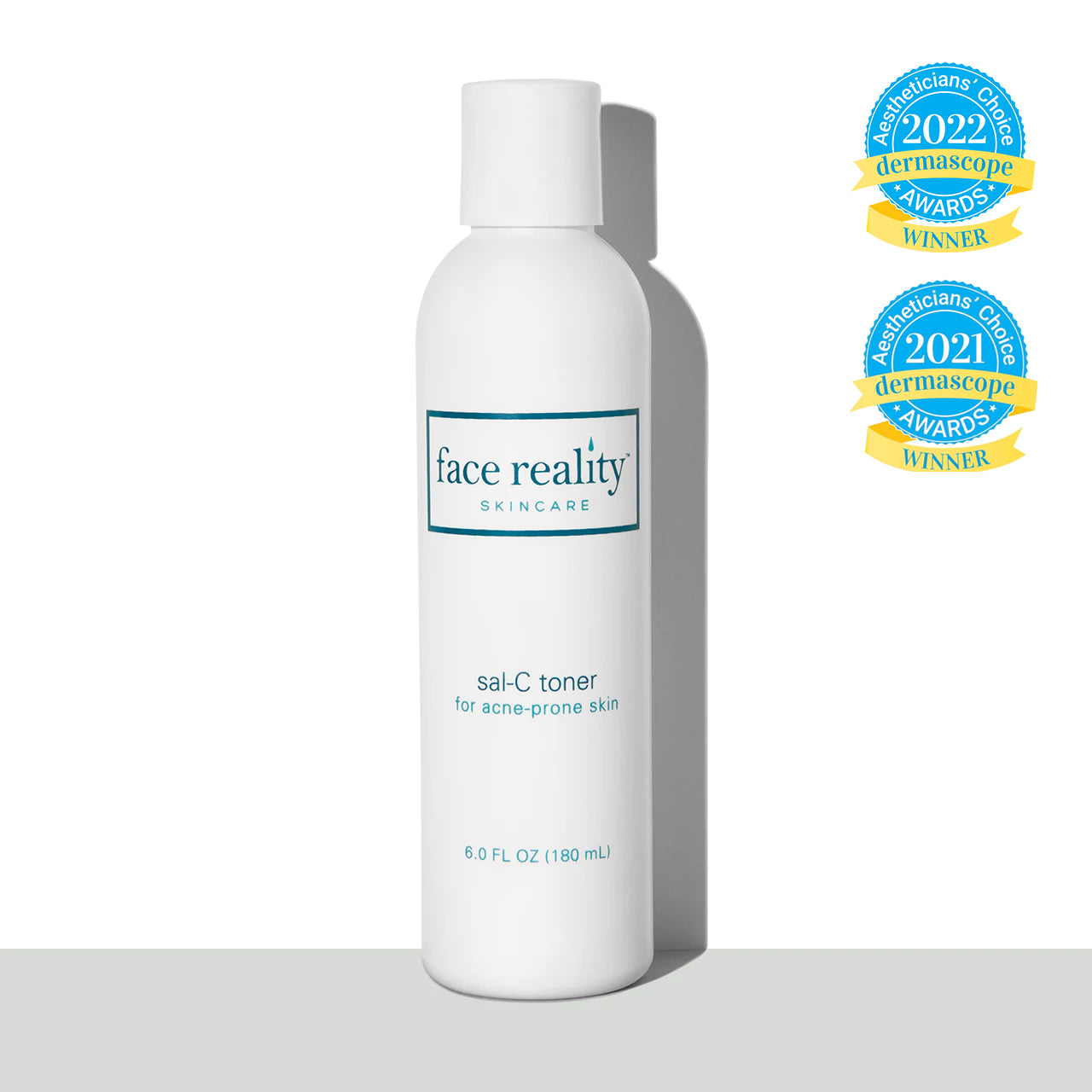white six  ounce bottle of Face Reality Sal C toner in front of white background on a grey surface with Dermascope Aestheticians' Choice awards winner for 2021 and 2022 award stamps
